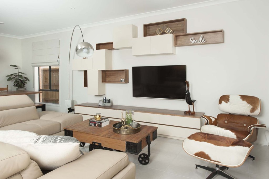 Custom made entertainment units with oak and a off-white stain with random shelving above C045