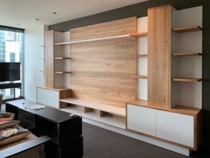 Holy blackbutt timber custom entertainment units centre with white front cupboards