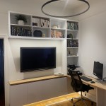 Custom white entertainment unit with a timber top and shelving above