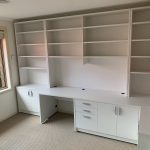 Modular white fitted desk and hutch with a corner bookcase