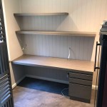 Custom fitted desk with integrated drawers and floating shelves