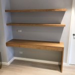 Custom floating fitted desk with a waterfall edge and shelving above